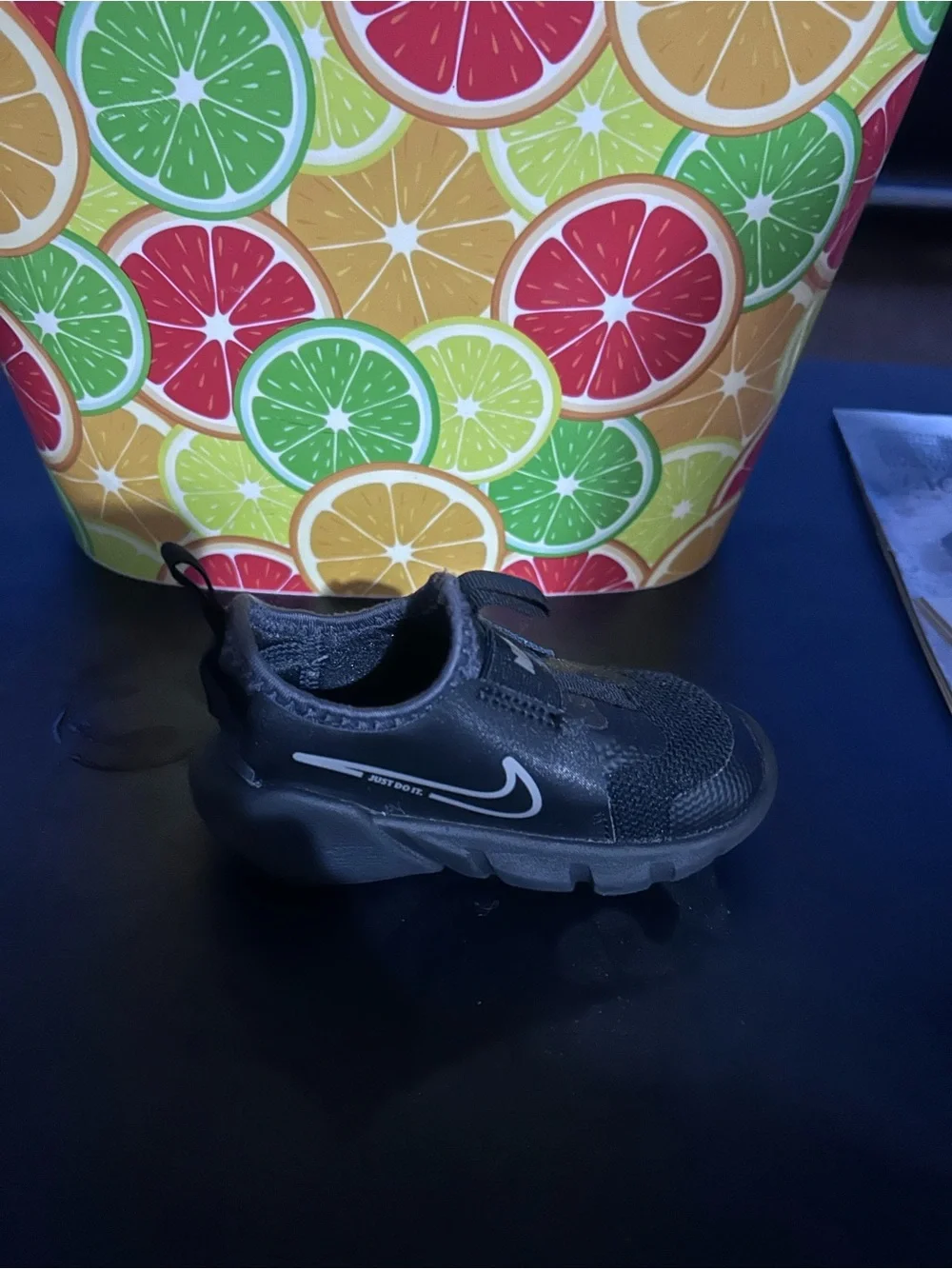 Nike Youth Black Slip-On Sneaker with White Swoosh and Blue Insole